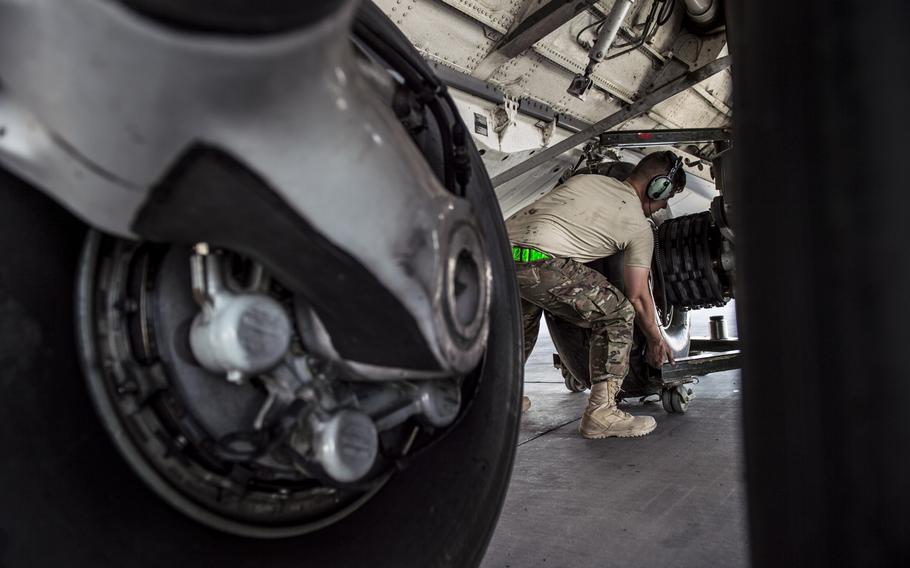 Airman with the 5th Expeditionary Air Mobility Squadron lift a C-17 Globemaster III tire into place during a tire change at an undisclosed location in Southwest Asia on Tuesday, March 21, 2017.