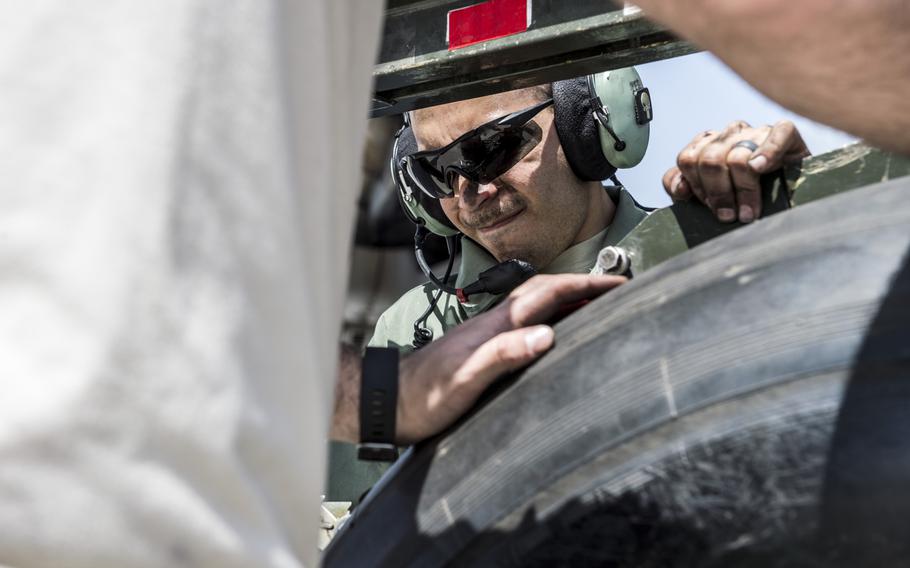 Staff Sgt. Carlos Borges, a crew chief with the 5th Expeditionary Air Mobility Squadron helps fellow airmen hold a 390-pound C-17 Globemaster III tire in place while attaching it to a lift during a tire change at an undisclosed location in Southwest Asia on Tuesday, March 21, 2017.