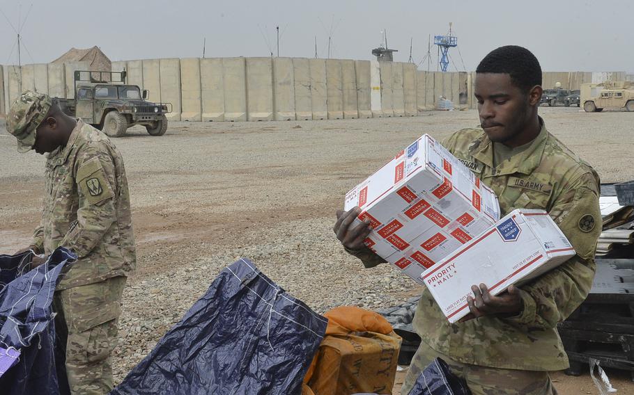 Spc. Telvin Boseman, 22, of Charlotte, N.C., sorts care packages from a mail delivery at Qayara Airfield West, Iraq, March 17, 2017. Mail is one of the few morale boosters on base here, about 40 miles south of Mosul, where troops are supporting an ongoing campaign to oust Islamic State militants from Mosul.