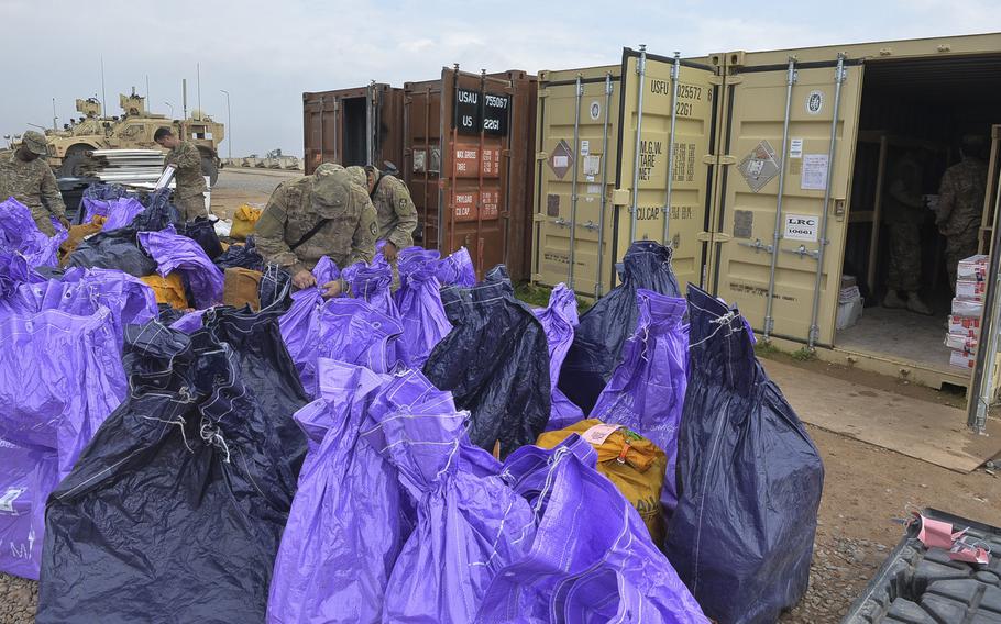 Soldiers of the 678th Adjutant General Company Postal Platoon sort mail at Qayara Airfield West, Iraq, March 17, 2017. Troops say any care package from home is a good one, and they often receive them from strangers through groups such as ''Adopt a Platoon.'' Mail arrives here about once every two weeks.