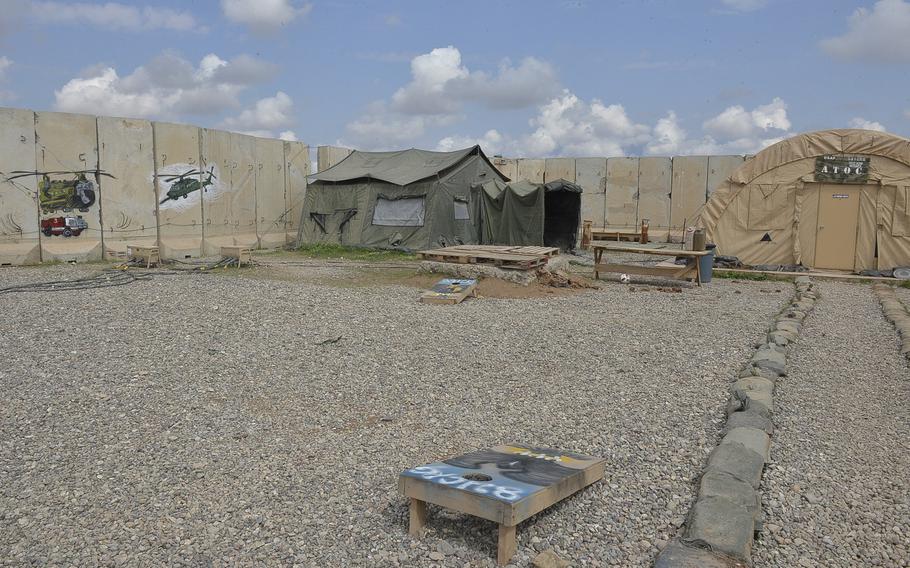 Pictured here are cornhole boards in a gravel lot in an area where arimen of the 370th Air Expeditionary Advisory Group detachment work on Qayara Airfield West, Iraq. As the base is being built up, planners struggle to balance the investment into the installation with the need to avoid ''frivolous'' niceities on a base destined to be returned to the Iraqi government.
