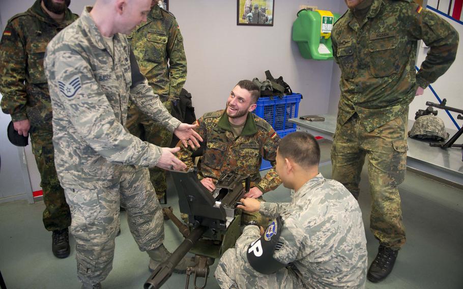Staff Sgts. Caleb Bruce, left, and Andrew Deleon-Guerrero show Spc. Kevin Kockeritz how to operate a Mk 19 grenade launcher in Kaiserslautern, Germany, on Thursday, March 23, 2017.