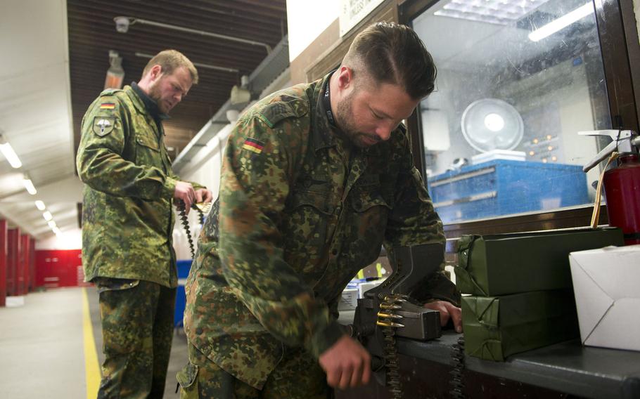 Cpls. Benedikt Dewald, right, and Christopher Brings load MG3 ammunition belts in Kaiserslautern, Germany, on Thursday, March 23, 2017.