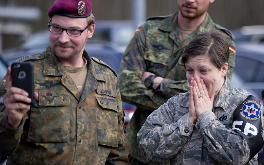 Cpl. Klaus Schmidt, left, and Tech Sgt. Kellie Sawn watch a German soldier testing the effects of a Tazer in Kaiserslautern, Germany, on Thursday, March 23, 2017.