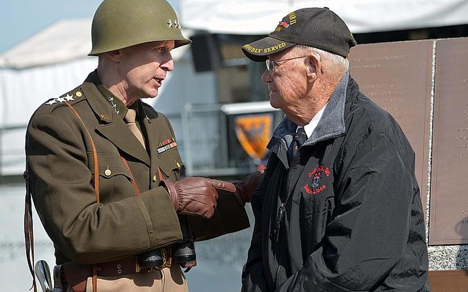 Lt. Gen. George S. Patton, aka Thomas Goode, talks to World War II veteran Robert Shelato at the dedication ceremony for the World War II Rhine River crossing monument in Nierstein, Germany, Saturday, March 25, 2017. Shelato, with the 249th Engineer Battalion, bridged the Rhine in March 1945, letting Patton's 3rd Army cross into the heart of Germany. Goode is a teacher at Ramstein High School.