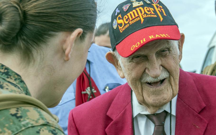 Battle of Iwo Jima veteran George Cattalona is greeted by Marines upon arriving on the island, now known as Iwo To, Saturday, March 25, 2017.