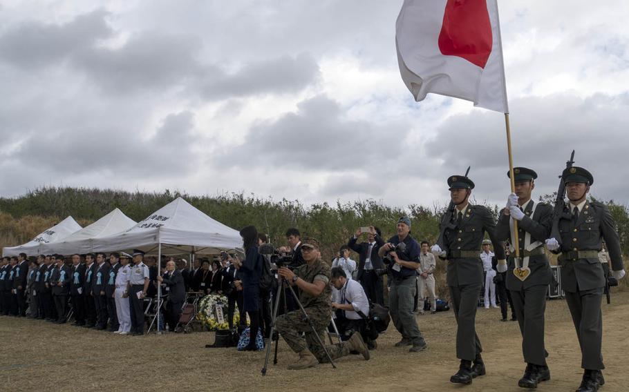 Japanese troops present the colors during a ceremony marking the 75th anniversary of the Battle of Iwo Jima, Saturday, March 25, 2017.