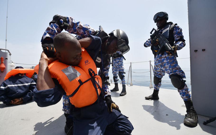 Sailors from the Ivory Coast search a role player in a search-and-seizure drill during the Obangame Express exercise, which brought together 32 nations to improve at-sea policing, Friday, March 24, 2017.