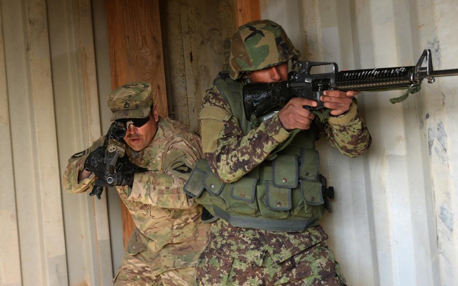 A U.S. Army adviser from Task Force Forge conducts a room-clearing drill with an Afghan trainee to demonstrate proper tactical procedures at the Regional Military Training Center in Helmand province, Afghanistan, March 8, 2017. Fears that the Taliban could capture a regional capital this year were heightened when the insurgents recently took the strategically important district of Sangin.