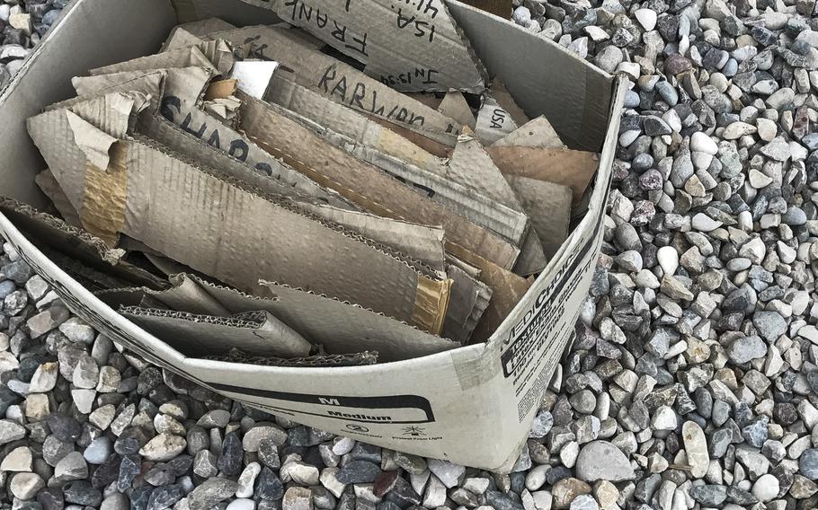 Volunteers who have served at the Samaritan's Purse field trauma hospital east of Mosul made arrows with their names, hometowns and distances from the hospital for a signpost in part of the hospital compound. A box of weather-beaten arrows is pictured here on March 13, 2017.