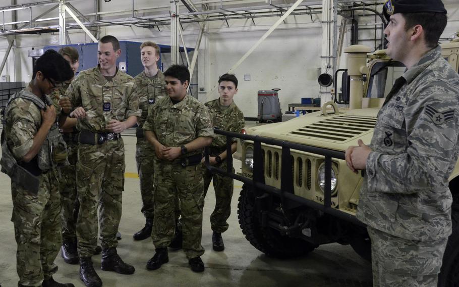 Royal Air Force Air Cadets try on a security forces vest during a demonstration of U.S. Air Force operations and equipment at RAF Lakenheath, England, Friday, April 7, 2017.