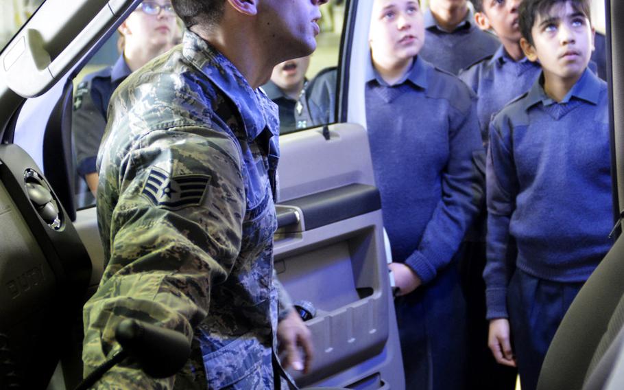 An airman shows Royal Air Force Air Cadets how to operate the lights on an ambulance during a tour of U.S. Air Force operations and equipment at RAF Lakenheath, England, Friday, April 7, 2017.