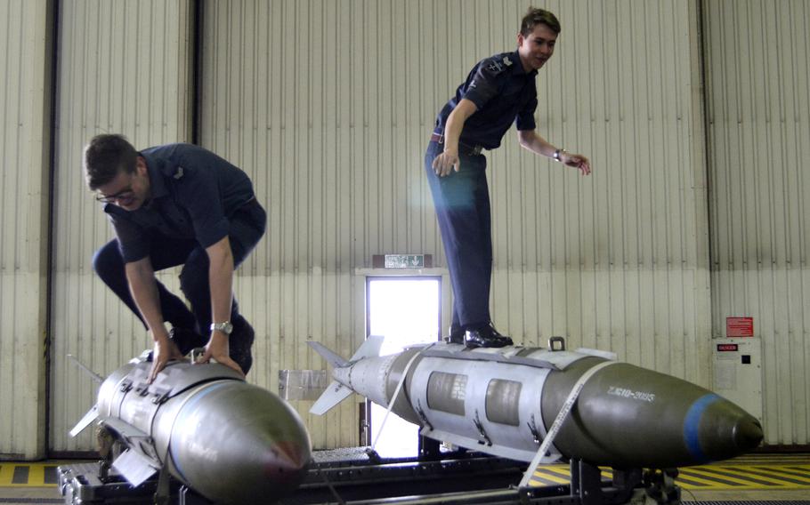 Royal Air Force Air Cadets pretend to surf on training missiles during a tour of U.S. Air Force operations and equipment at RAF Lakenheath, England, Friday, April 4, 2017. The RAF's Air Cadets, the service's youth organization, numbers more than 50,000 members.