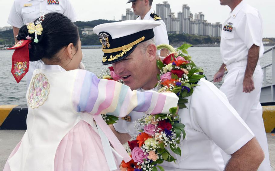 Cmdr. John W. Stafford of the Los Angeles-class attack submarine USS Cheyenne is welcomed to Busan, South Korea, Tuesday, June 6, 2017.