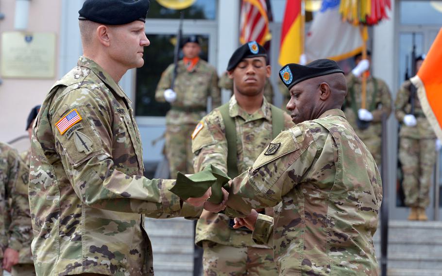 Col. Rob Parker, left, the 5th Signal Command's last commander, and  2nd Signal Brigade Command Sgt. Maj. Gregory Rowland case 5th Signal's colors at the unit's inactivation ceremony at Clay Kaserne in Wiesbaden, Germany, Friday, Aug. 4, 2017.