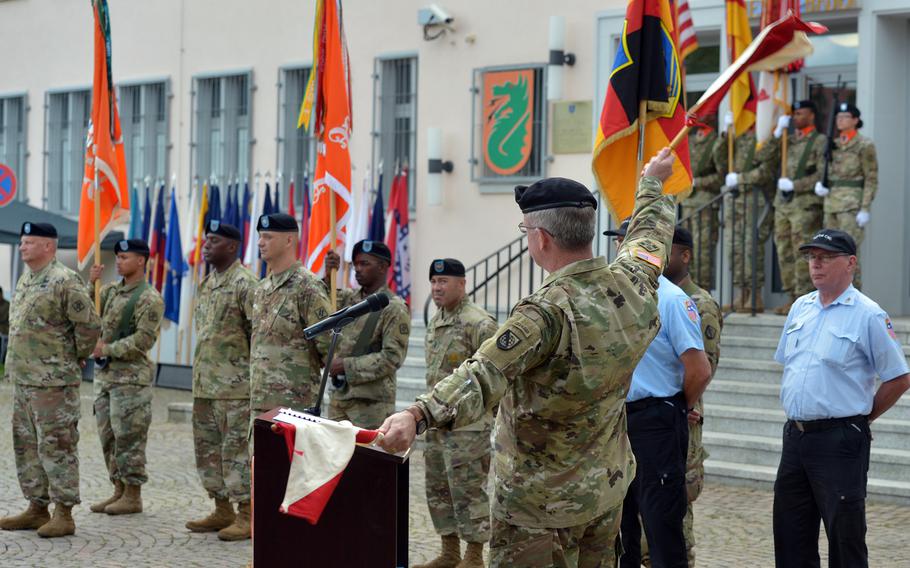 Maj. Gen. John Baker, commander of U.S. Army Network Enterprise Technology Command, uses old-fashioned signal flags during his speech at the 5th Signal Command's inactivation ceremony at Clay Kaserne in Wiesbaden, Germany, Friday, Aug. 4, 2017.