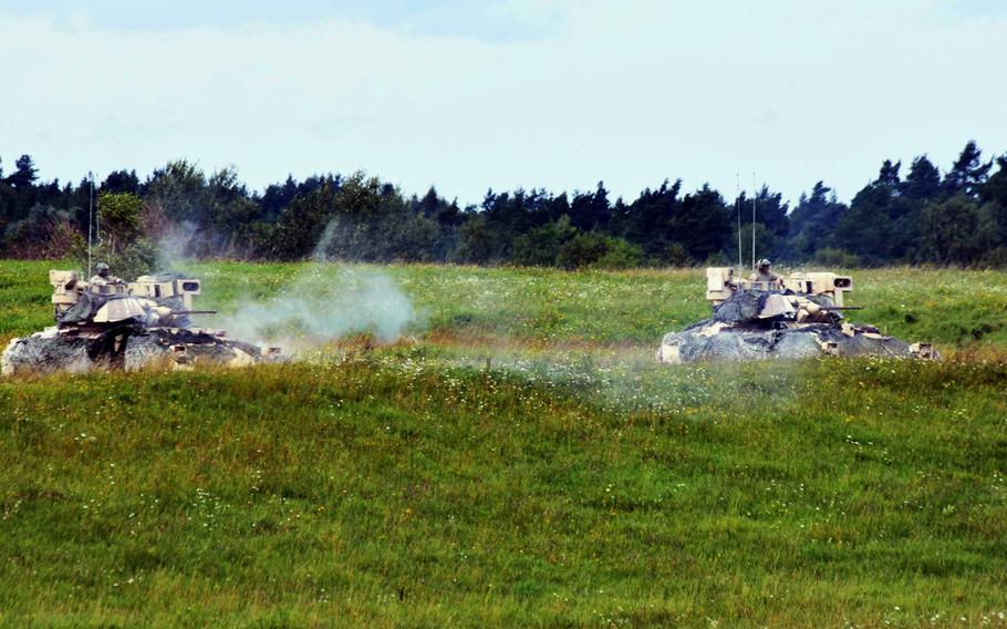 Bradley Fighting Vehicles with the Army's 1st Battalion, 68th Armored Regiment, fire their machine guns during a live fire exercise in Grafenwoehr, Germany, Friday, Aug. 4, 2017.