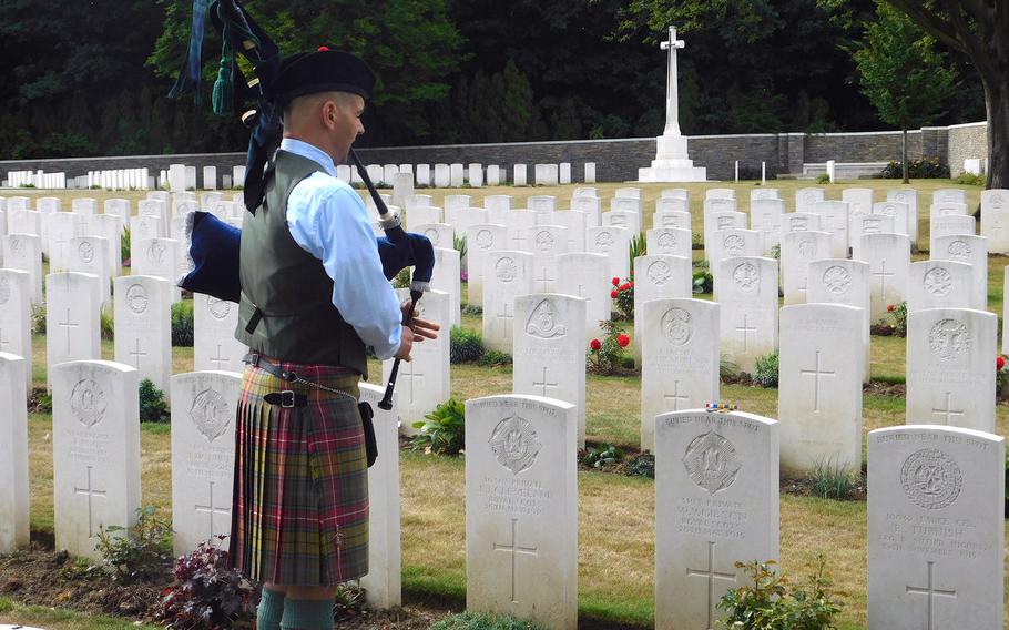 Lt. Col. Robert Gunther, an operations officer with U.S. Army Europe, plays the bagpipe over the grave of his ancestor, Walter Young Gibson, who fell at Ypres in 1915 as a member of the British army. Gibson was Gunther's maternal great-uncle.