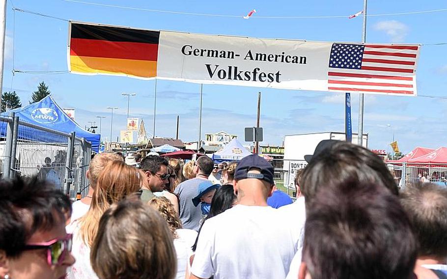 American and German families wait in line at the entrance of the 59th annual German-American Volksfest in Grafenwoehr, Germany, Saturday, August 5, 2017.