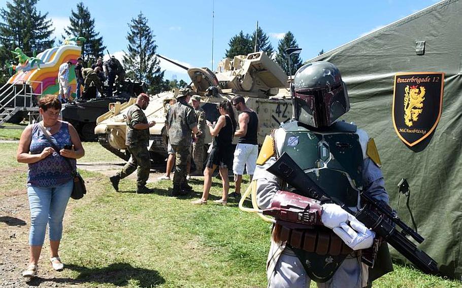"Intergalactic Bounty Hunter" Boba Fett takes time to experience German and American culture and look at military equipment at the German-American Volksfest in Grafenwoehr, Germany, on Saturday, Aug. 5, 2017.
