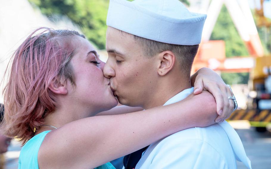Justen Turner, an aviation boatswain's mate (fuel) airman, reunites with his wife after the aircraft carrier USS Ronald Reagan returned to Yokosuka Naval Base, Japan, after a nearly three-month deployment, Tuesday, Aug. 9, 2017.