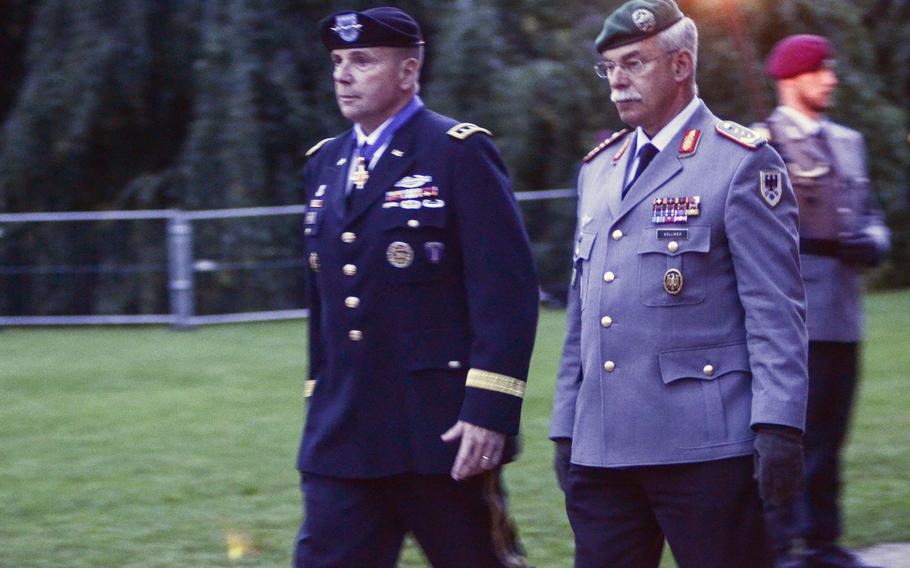 Lt. Gen. Ben Hodges, commander of U.S. Army Europe, and Bundeswehr Chief of Staff Lt. Gen. Joerg Vollmer walk to their seats at a farewell playing of the Grosser Zapfenstreich, or Grand Tattoo, for Hodges, Thursday, Aug. 10, 2017 in Wiesbaden, Germany.
