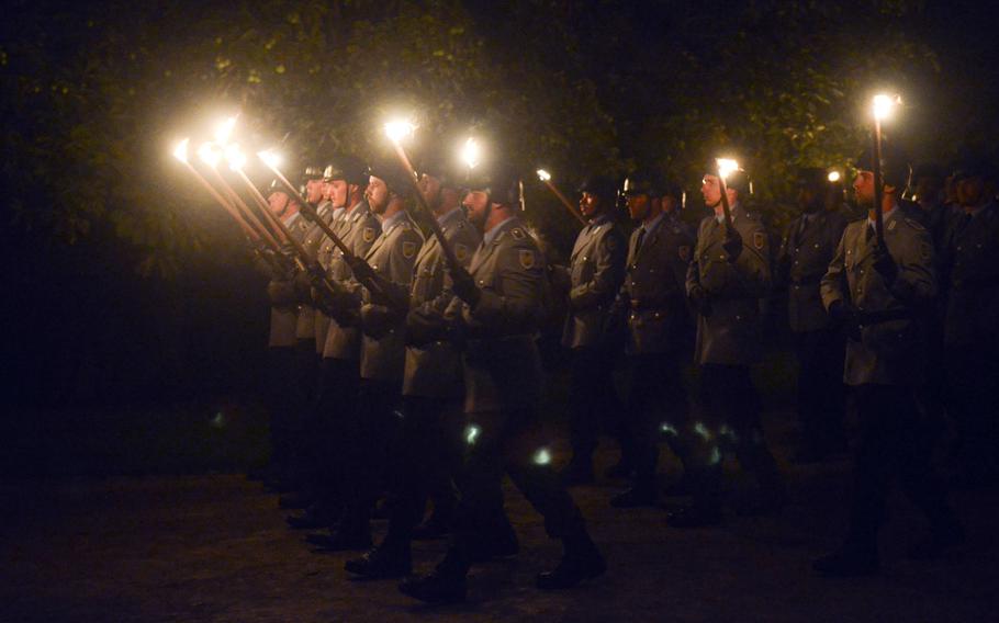 Bundeswehr soldiers march past following the conclusion of the Grosser Zapfenstreich, or Grand Tattoo, Thursday, Aug. 10, 2017 at the grounds of Biebrich Palance in Wiesbaden, Germany.