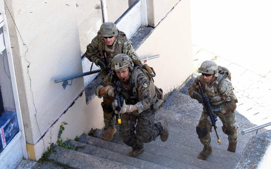 Georgian soldiers and a U.S. Marine run toward a hostile threat during training in Hohenfels, Germany, Tuesday, August 15, 2017.