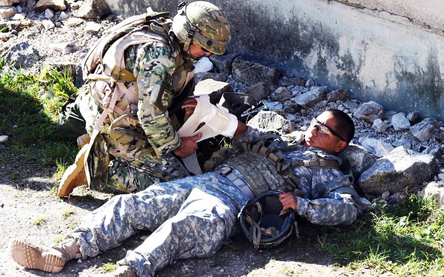 A Georgian soldier provides first aid to an American soldier during training in Hohenfels, Germany, Tuesday, Aug. 15, 2017. The 15-day mission rehearsal exercise, which ends on Aug. 22, is the final step to certifying the Georgian unit is ready to deploy with coalition forces in support of Operation Freedom Sentinel.