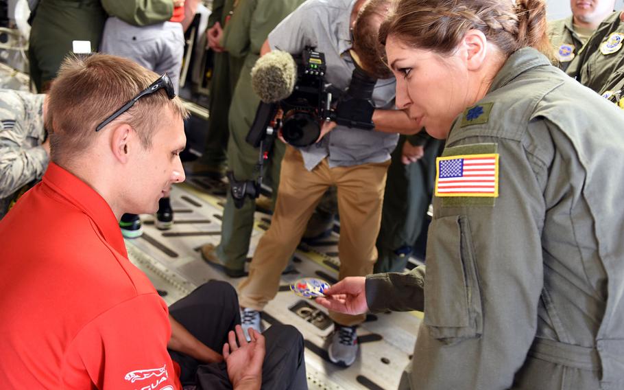 Lt. Col. Renee Matos presents an aeromedical military patch to Chris Klodt on Tuesday, Aug. 15, 2017, at Ramstein Air Base, Germany. Klodt, a former corporal with Canadian Forces, was injured in Afghanistan in 2006. The U.S. Air Force medically evacuated him to Germany, where he received care at Landstuhl Regional Medical Center. He returned to Germany to help mark the journey of the Invictus Spirit Flame as it travels from Afghanistan to Canada for the upcoming Invictus Games in Toronto next month.