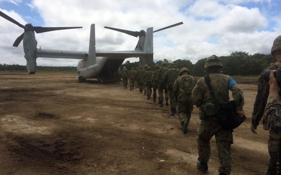 Okinawa-based Marines and Japan Ground Self-Defense Force troops load into an MV-22 Osprey during Northern Viper drills in Hokkaido, Japan, Friday, Aug. 18, 2017.