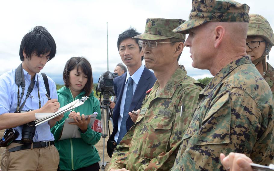 Marine Corps and Japan Ground Self-Defense Force officials speak to reporters about the MV-22 Osprey tilt-rotor aircraft's participation in Northern Viper drills in Hokkaido, Japan, Friday, Aug. 18, 2017.