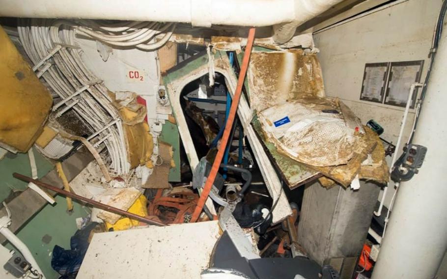 This screenshot of a photo from a Navy investigative report shows a lounge in Berthing 2 after floodwaters were drained from the USS Fitzgerald.