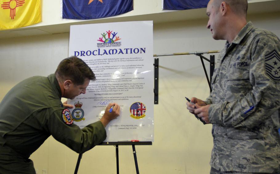 100th Air Refueling Wing Commander Col. Christopher Amrhein, left, and Command Chief Master Sgt. Curtis Stanley sign a proclamation for diversity inclusion during the second annual Diversity and Inclusion Day at RAF Mildenhall, England, on Aug. 18, 2017.