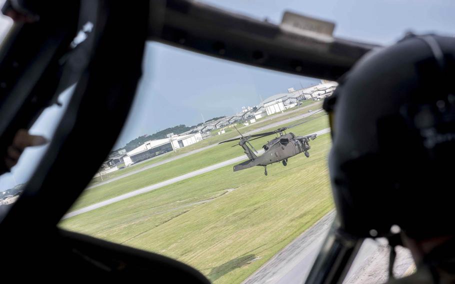 Army Black Hawk helicopters take off in formation at Kadena Air Base, Japan, Aug. 1, 2017.