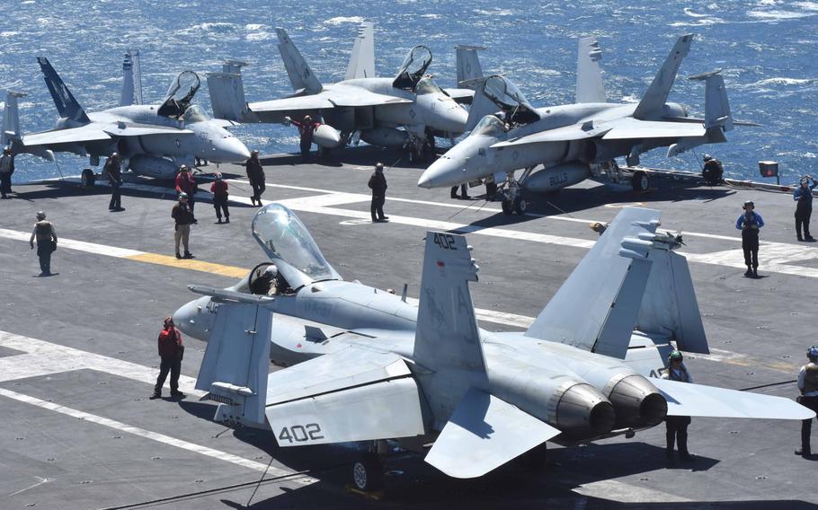 Crews fire up a cluster of F/A-18 Super Hornets as part of pre-flight preparation on the USS George H.W. Bush in the Persian Gulf in April, 2017.