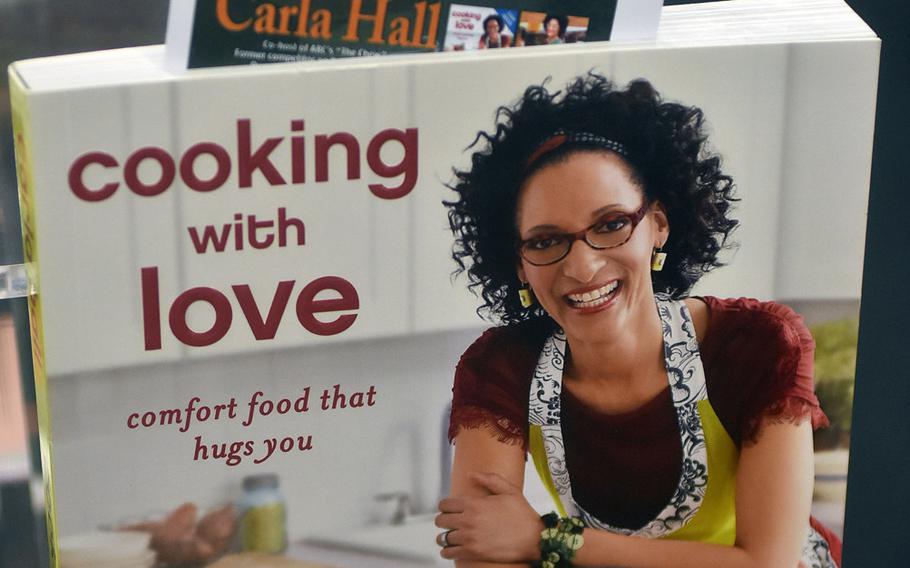 Celebrity chef Carla Hall is currently working on her third book. Her first, "Cooking with Love," was on sale at the AAFES exchange at Aviano Air Base on Wednesday, Aug. 23, 2017, for fans to pick up a copy and get it autographed.