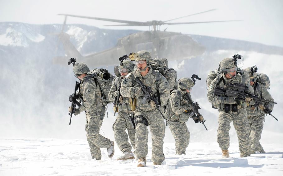 Soldiers wearing Extended Cold Weather Clothing System gear move through a snowy terrain after dismounting from a helicopter in March 2010. Army scientists are working with nanotechnology to produce cold-weather uniforms that will heat up when switched on and wick moisture away more efficiently.