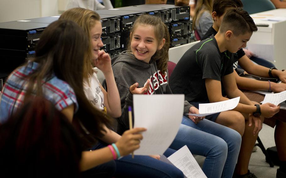 Seventh-grade students compare schedules during the first day of school at Kaiserslautern Middle School at Vogelweh, Germany, on Monday, Aug. 28, 2017.