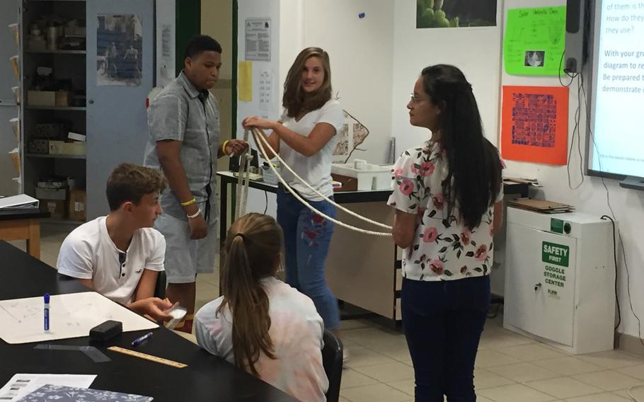 Geometry students use a rope to show how to calculate a triangle during their first day of classes, Monday, Aug.28, 2017, at Naples High School near Naples, Italy.