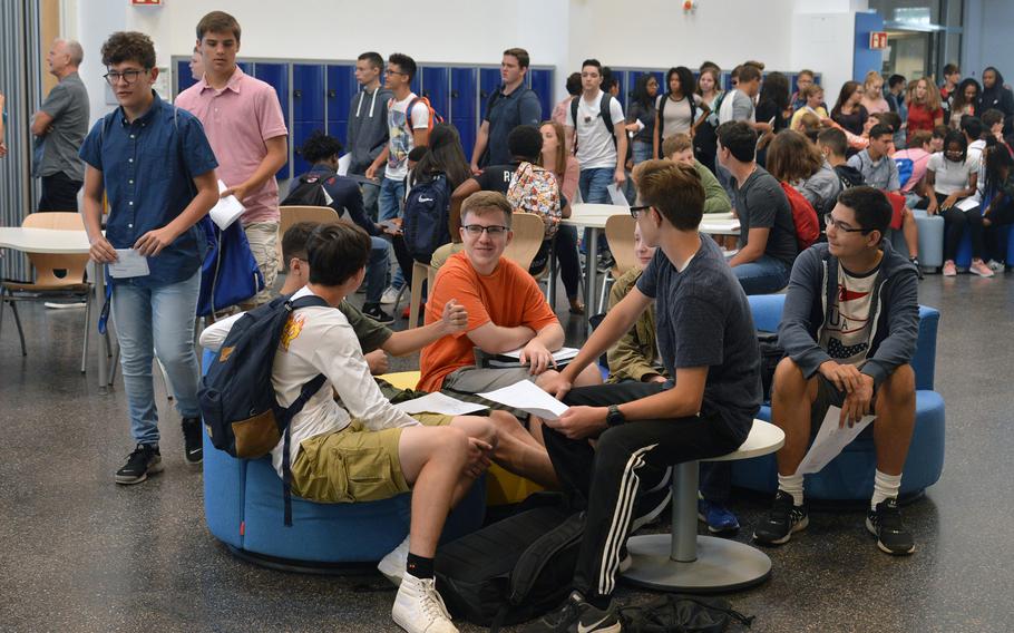 Students talk about their new school schedules and other things in the central common area of the new Wiesbaden High School as they wait to go to an orientation, Monday, Aug. 24, 2017. It is the first 21st-century-designed school in the Department of Defense Education Activity.