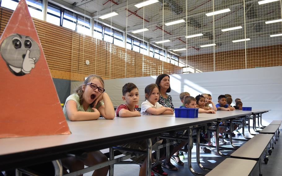 Going back to school can be exhausting. A second-grader at Ramstein Elementary School in Germany yawns while listening to a talk about cafeteria rules on Monday, Aug. 28, 2017.