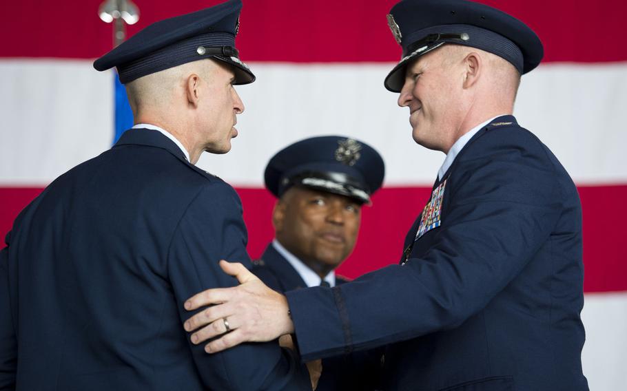 Cols. Joseph McFall, right, and Jason Bailey shake hands during the 52nd Fighter Wing's change-of-command ceremony at Spangdahlem Air Base, Germany on Tuesday, Aug. 29, 2017. Bailey assumed command of the wing from McFall during the ceremony.