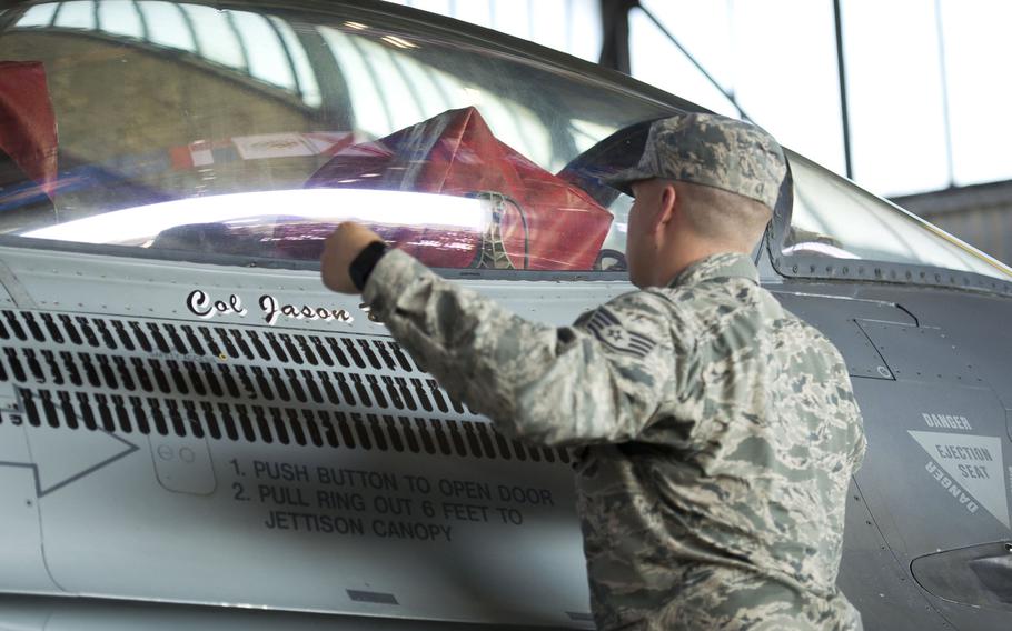 Col. Jason Bailey's name is unveiled on an F-16 during the 52nd Fighter Wing's change-of-command ceremony at Spangdahlem Air Base, Germany on Tuesday, Aug. 29, 2017. Bailey is the new wing commander.
