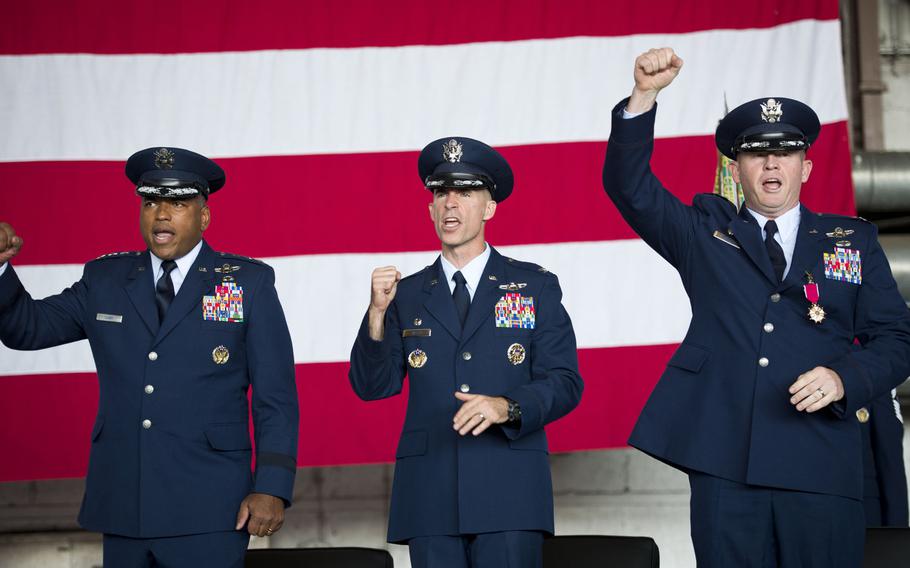 From left, 3rd Air Force Commander Lt. Gen. Richard Clark sings the Air Force song with Cols. Jason Bailey and Joseph McFall at the end of the 52nd Fighter Wing's change-of-command ceremony at Spangdahlem Air Base, Germany on Tuesday, Aug. 29, 2017.
