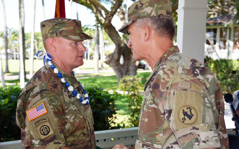 Maj. Andrew Downey receives a congratulatory handshake from Gen. Robert Brown, commander of U.S. Army Pacific, after a ceremony at Fort Shafter, Hawaii, Tuesday, Aug. 29, 2017. Downey was awarded the Soldier's Medal, the Army's highest peacetime award for valor.