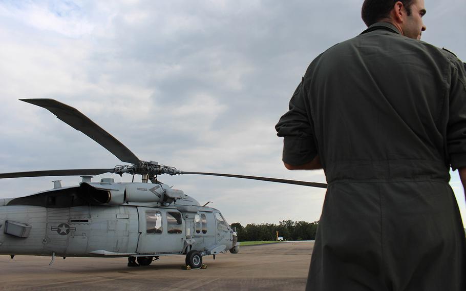Navy pilot Lt. Cmdr. Pat Dunn gazes at a HSC-7 in College Station, TX.  Dunn is a part of the  Dusty Dogs of the Helicopter Sea Combat Squadron, based of out Norfolk, VA, who assisted in the rescue mission, caused by Hurrcane Harvey.