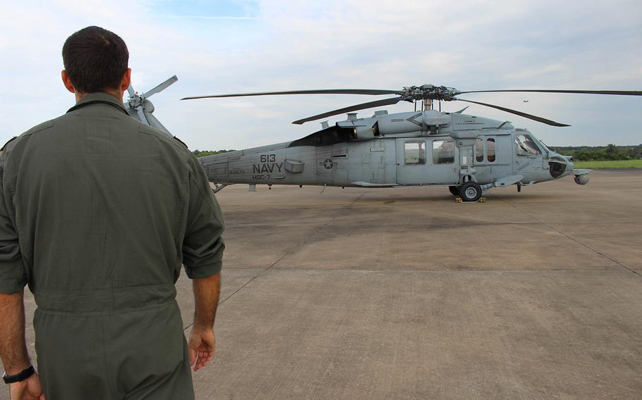 Navy pilot Lt. Cmdr. Pat Dunn walks towards a HSC-7 in College Station, TX.  Dunn is a part of the  Dusty Dogs of the Helicopter Sea Combat Squadron, based of out Norfolk, VA, who assisted in the rescue mission, caused by Hurrcane Harvey.