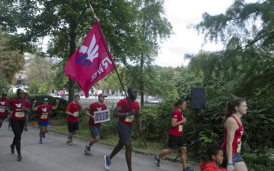 Soldiers and family members of U.S. Army Garrison run a celebratory lap around the Kurpark in downtown Wiesbaden after the conclusion of a 25-hour relay race, Sunday, Sept. 10, 2017. The 12-soldier team, the only all-American outfit, finished second of 11 teams in the race's competitve division.