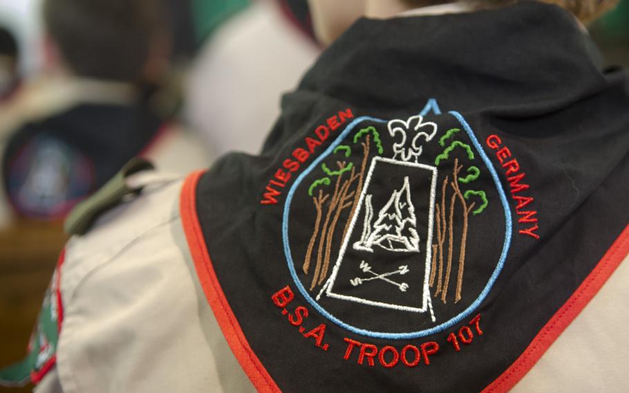 A volunteer Scout leader wears a neckerchief with the Wiesbaden Boy Scout Troop 107 seal during a meeting in Wiesbaden Monday, Sept. 18, 2017. The troop has been serving the community for 60 years, an anniversary marked at the meeting.